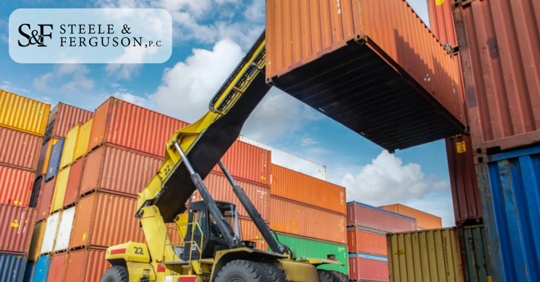 shipping containers lifted by heavy machinery